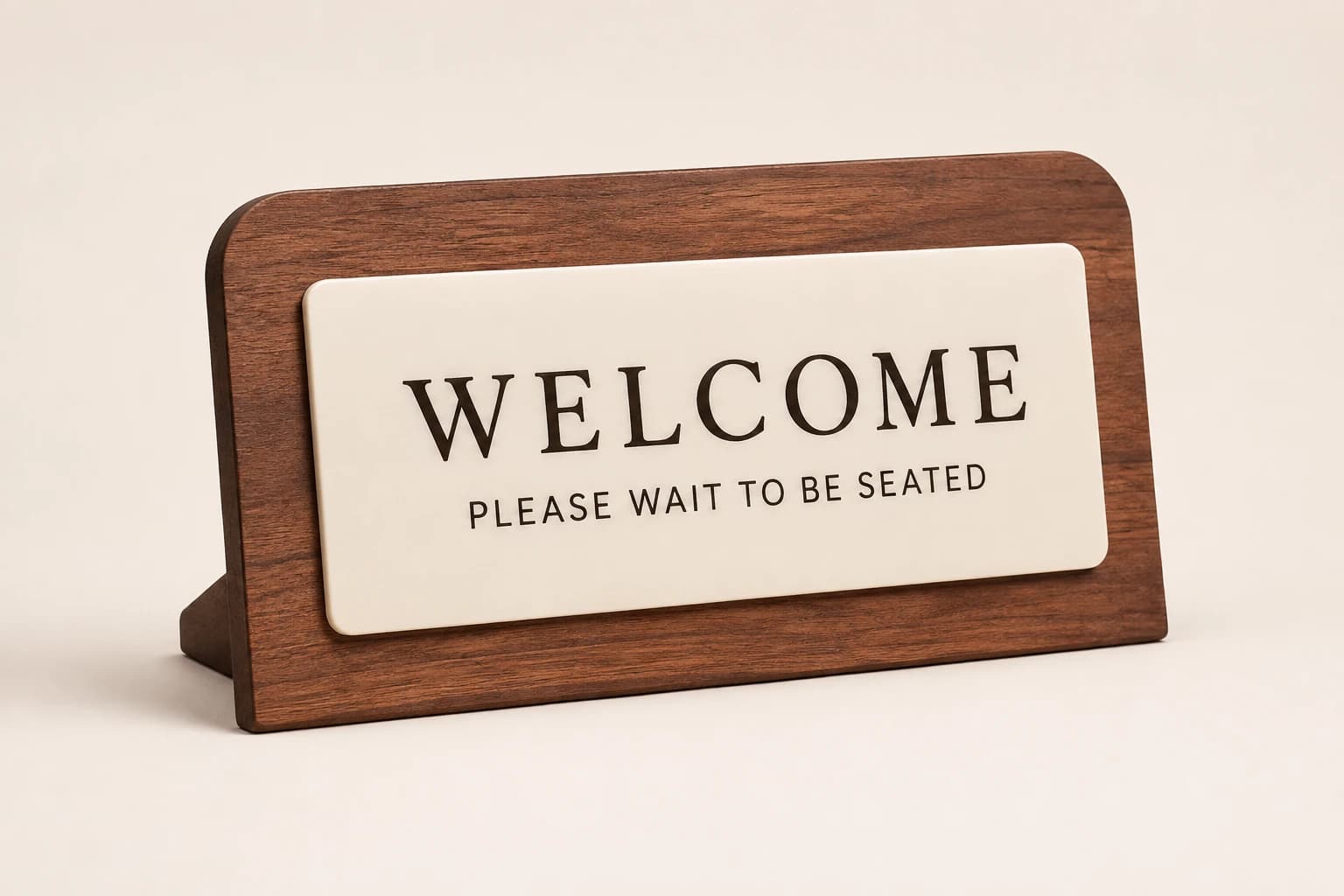 Walnut host-stand sign with a cream welcome and seating panel.